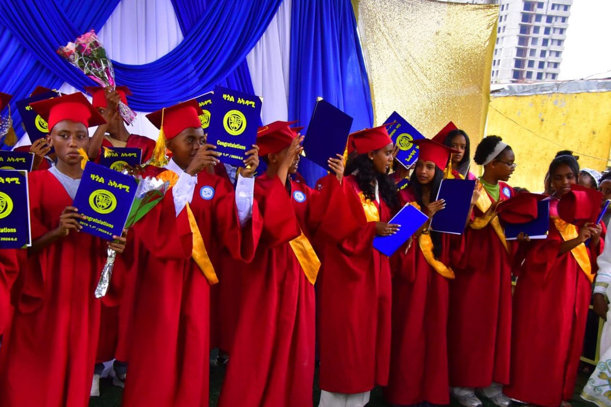 Zagol Academy 8th grade graduates holding their certificates